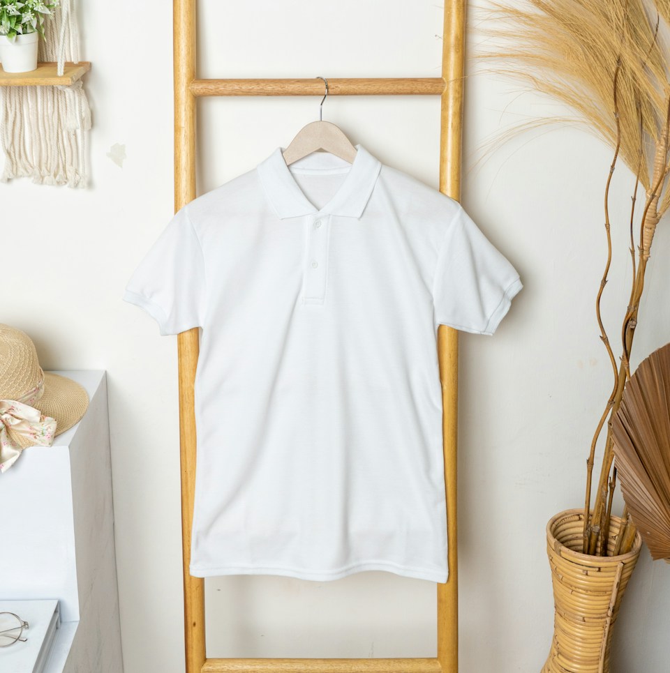 White polo shirt shown as a representative garment